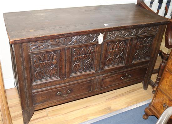 A 17th/18th century carved oak and pine mule chest W.125cm